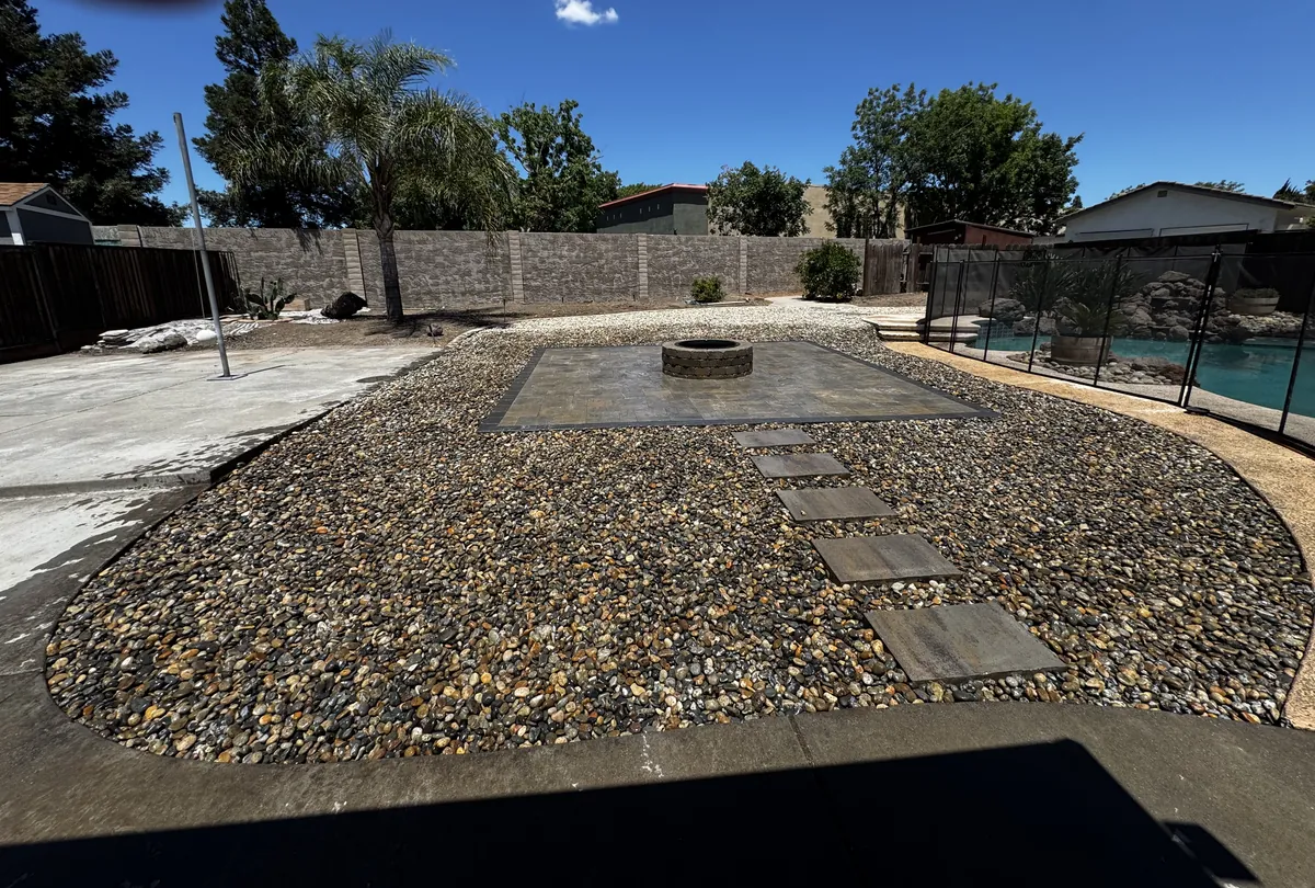 Decorative rock and fire pit by a pool in Tracy, CA