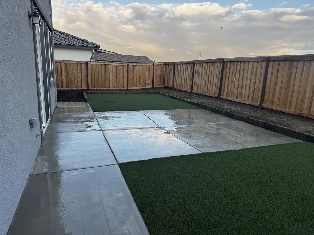 Backyard with concrete slab, artificial turf and mulch in Lathrop, CA