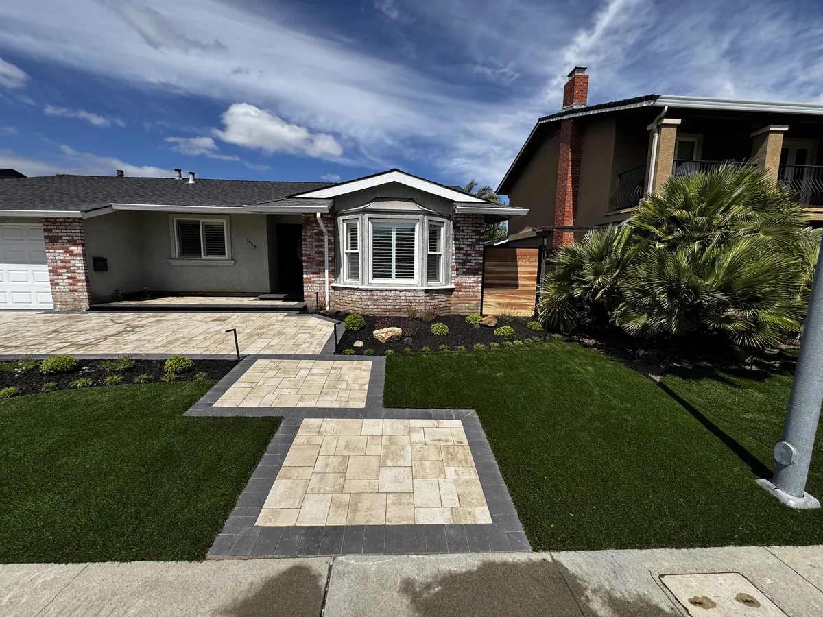 Travertine paver walkway with artificial turf and new plants in Pleasanton, CA